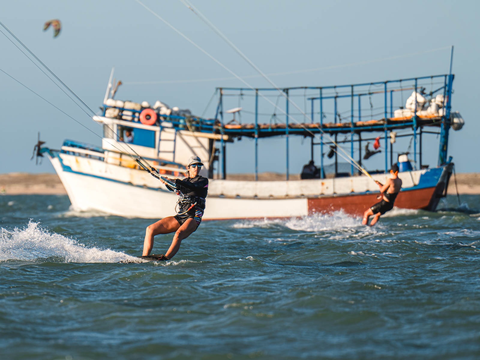 Kiteboarding in front of boat in Ilha do Guajiru brazil