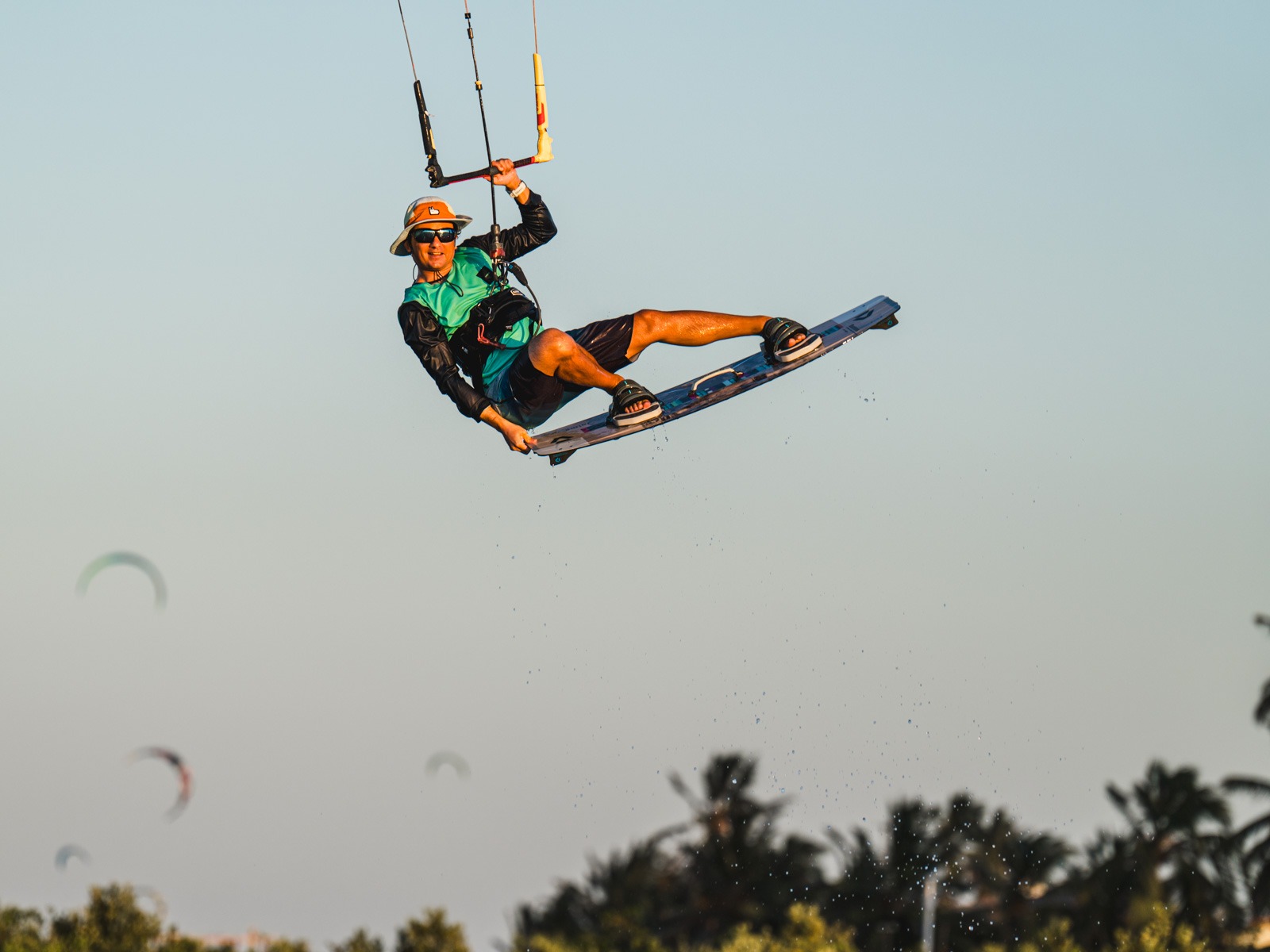 kiteboarder does a tail grab during SA Masterclass kiteboarding camp